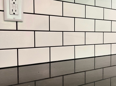 Black counter top with white backsplash tile